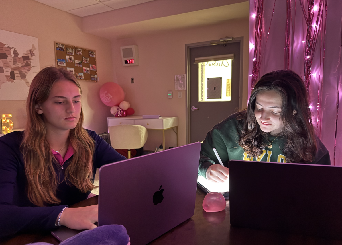 Madelyn Althage '25 and Veronica Estefani '25 work in the senior lounge. 